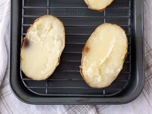 Baked potato sliced oven with a few black spots on the edges.