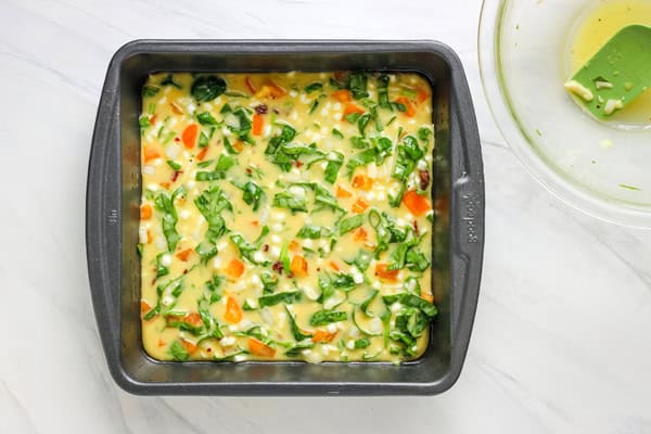 Veggie, egg, and cheese mixture in an 8 x 8 pan.