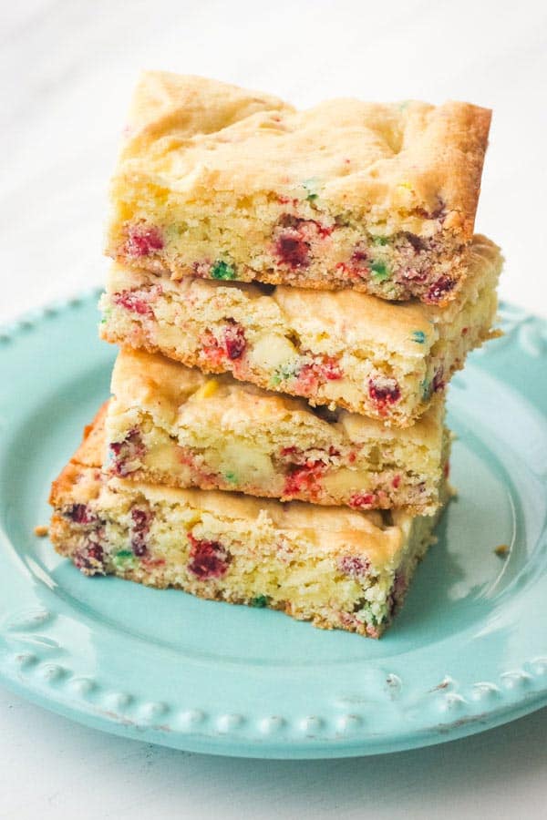 Stacked of Funfetti cake mix bars on a plate.