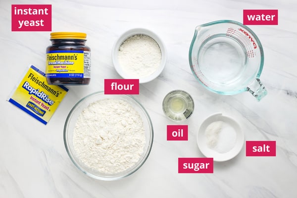 Bread ingredients in ramekins arranged on table with labels.