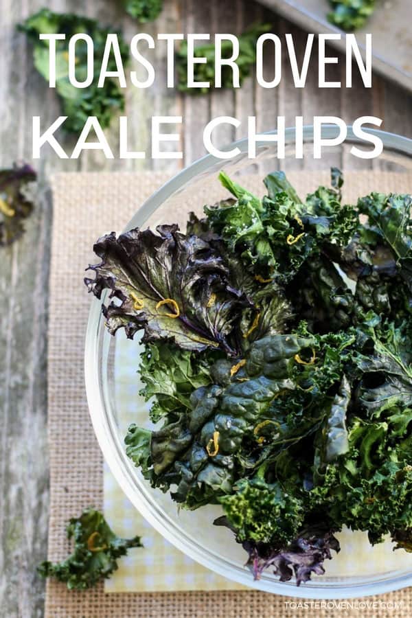 Flaky kale chips in a glass bowl.