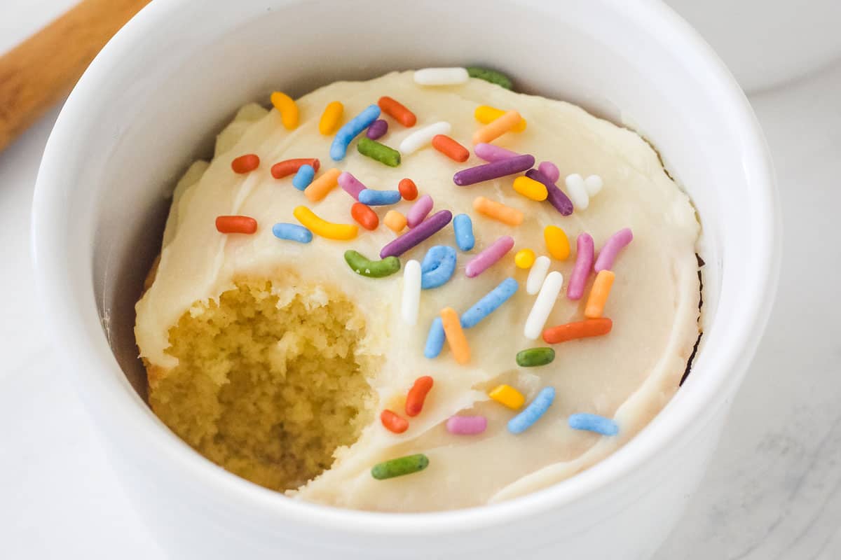 Closeup of frosted cake in a ramekin.