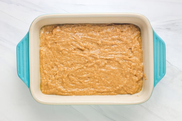Cake batter spread in a small baking dish.