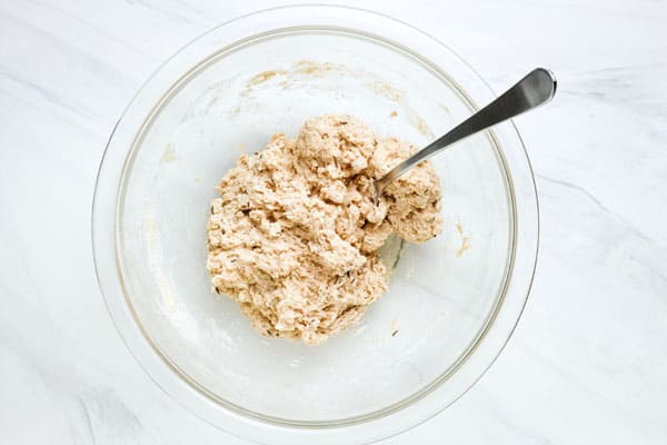 Bowl with a craggy dough with a fork sticking out of it.