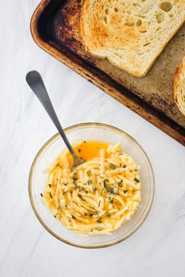 Small bowl with egg and shredded cheese combined.