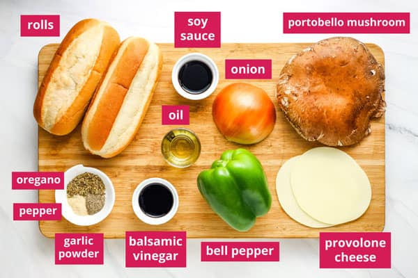 Sandwich ingredients arranged on a wood cutting board and labeled.