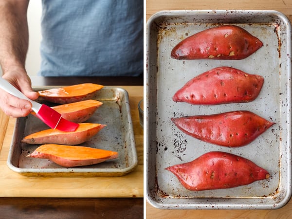 Baked sweet potatoes on a baking sheet brushed with oil.