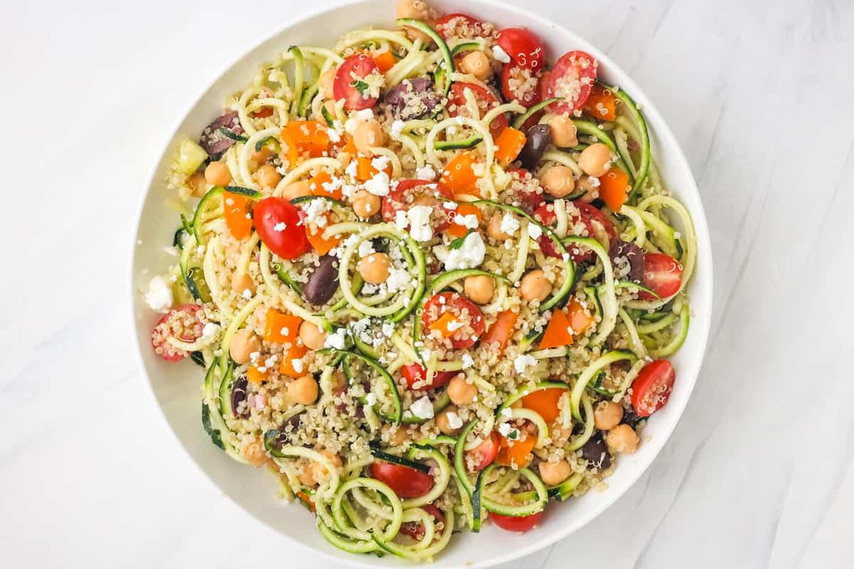 Large bowl of chickpea, quinoa, and zucchini noodles.