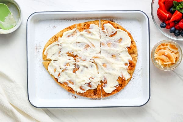 Flatbread on a pan spread with ricotta.