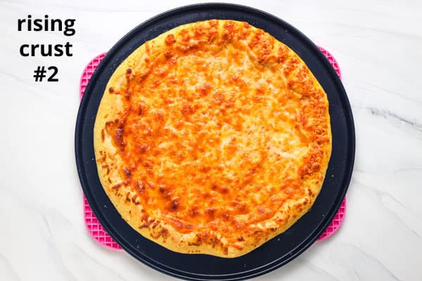 Overhead view of baked pizza with text "rising crust #2."