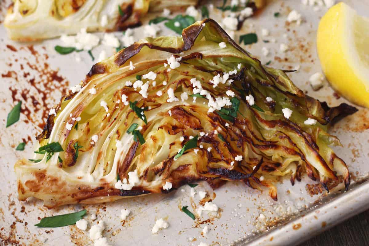 Close up of roasted cabbage on a sheet pan.