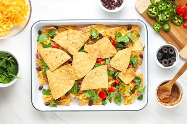 Pan of nachos with a second layer of chips.
