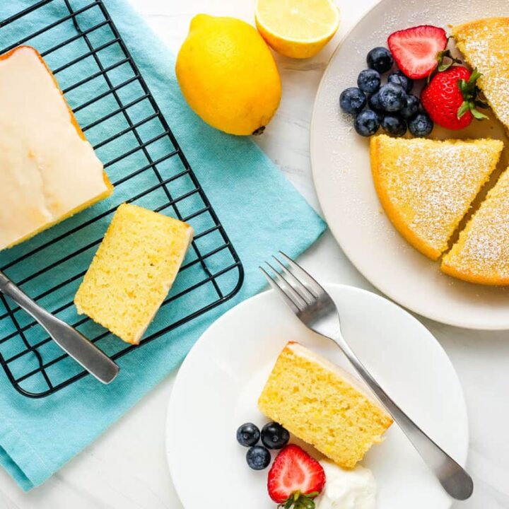 Overhead view of small cake on plate with berries and mini loaf sliced into pieces.