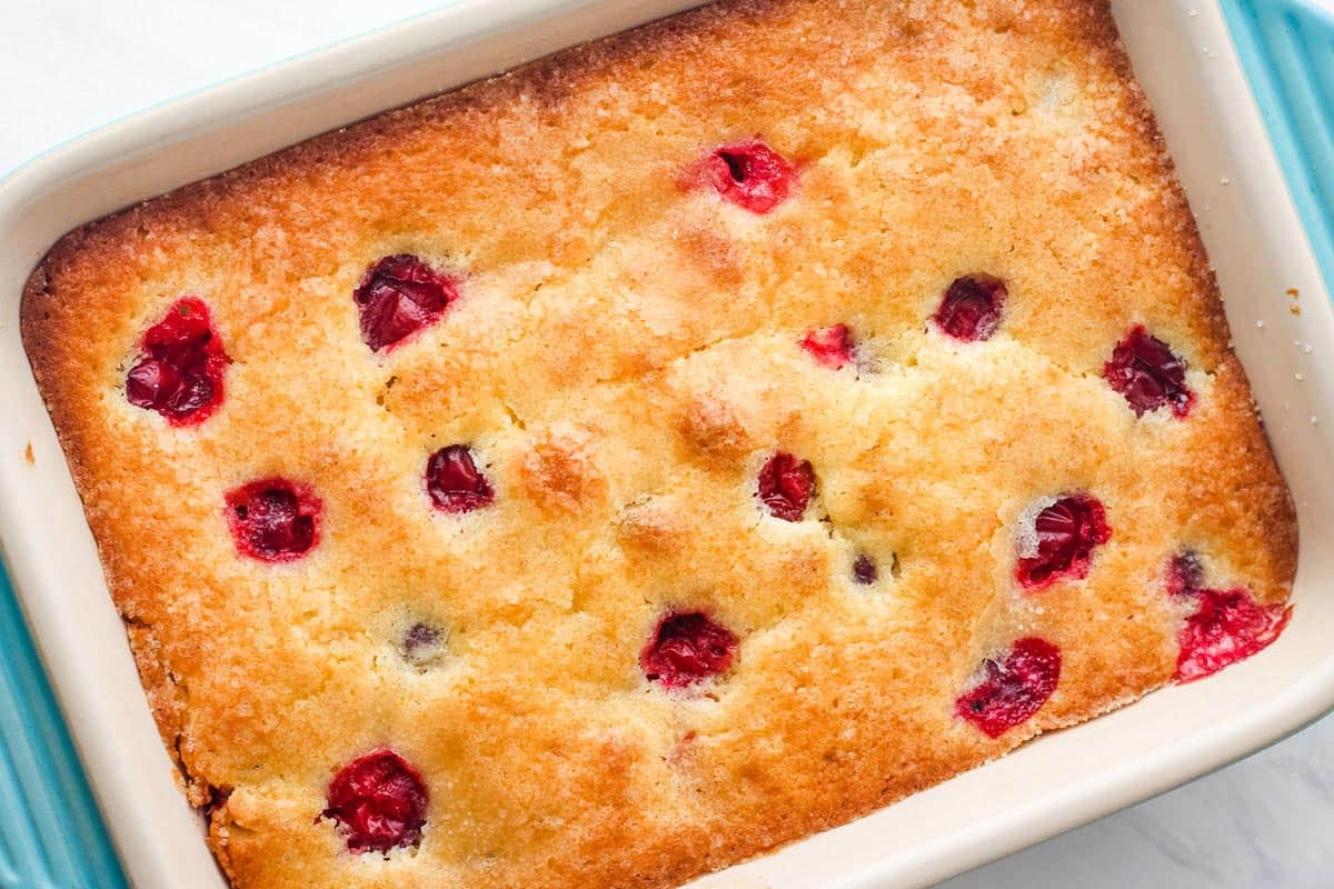 Overhead view of cranberry cake in a small baking dish.