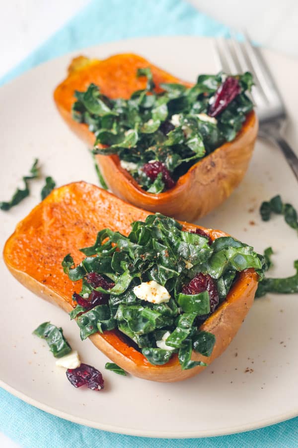 Honeynut squash stuffed with feta, cranberries, and kale salad.