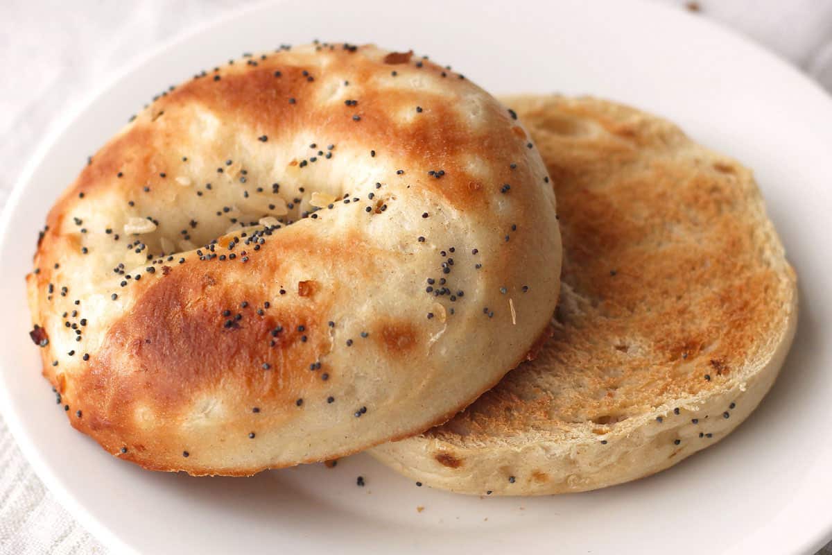 Closeup of toasted bagel halves on a plate.