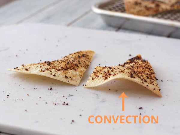 Chips side by side on a cutting board with arrow pointing to convection baked chip.
