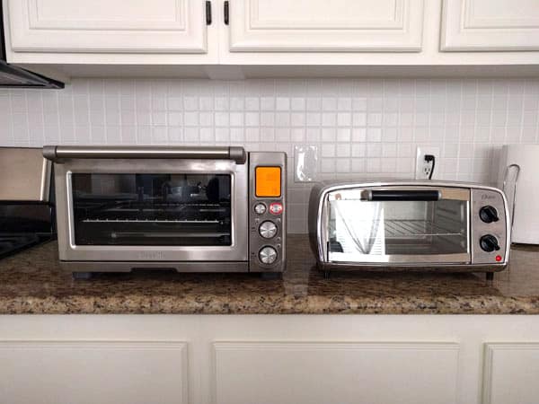 Large and small toaster ovens on a kitchen counter.